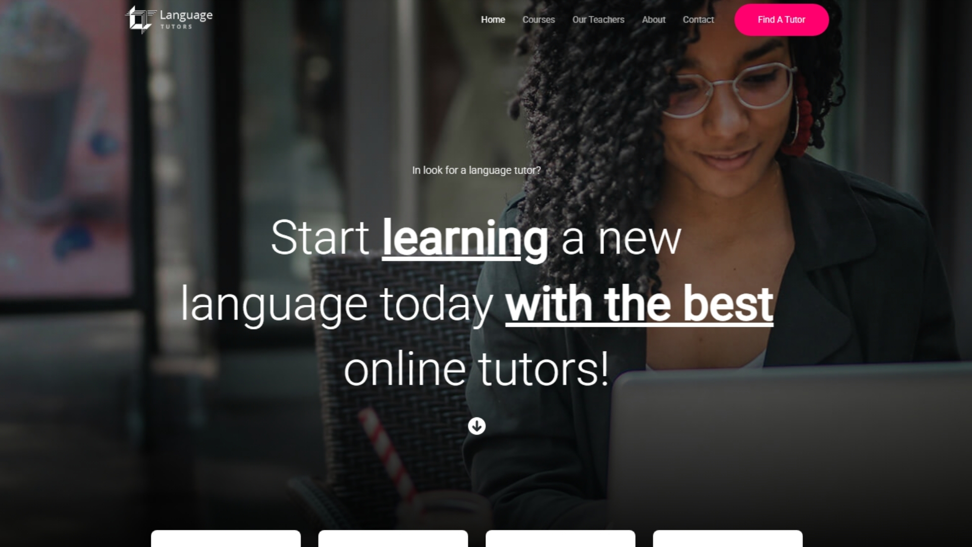 A woman with curly hair using a laptop in a modern setting, representing online language tutoring services.